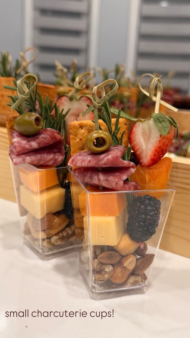Individual charcuterie cups with cheese, berries and nuts